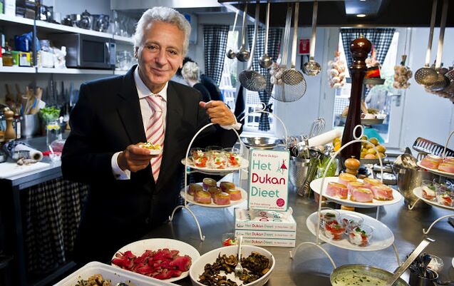 Pierre Dukan surrounded by diet dishes